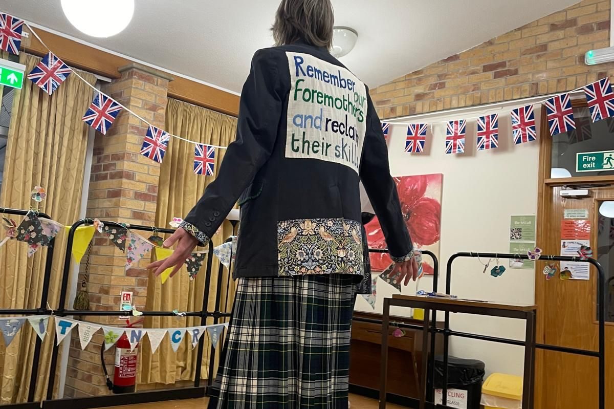 A van providing refills of food and household items, with customers lined up, near residential houses.